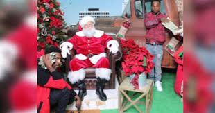 Viral photo of men flashing cash and firearm with Santa in Baton Rouge arrested