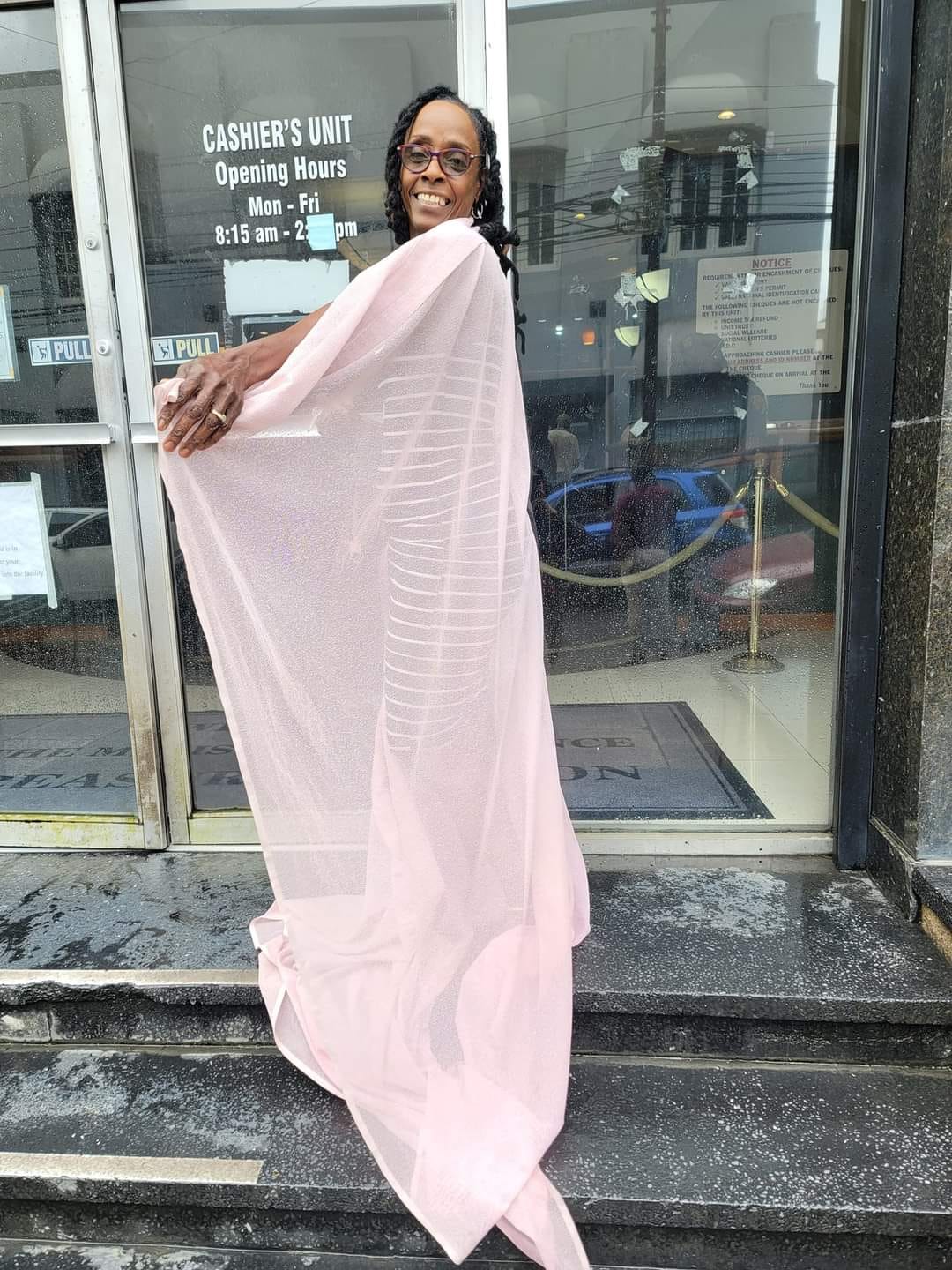 Woman drapes herself in a curtain after being denied entry into Central Bank
